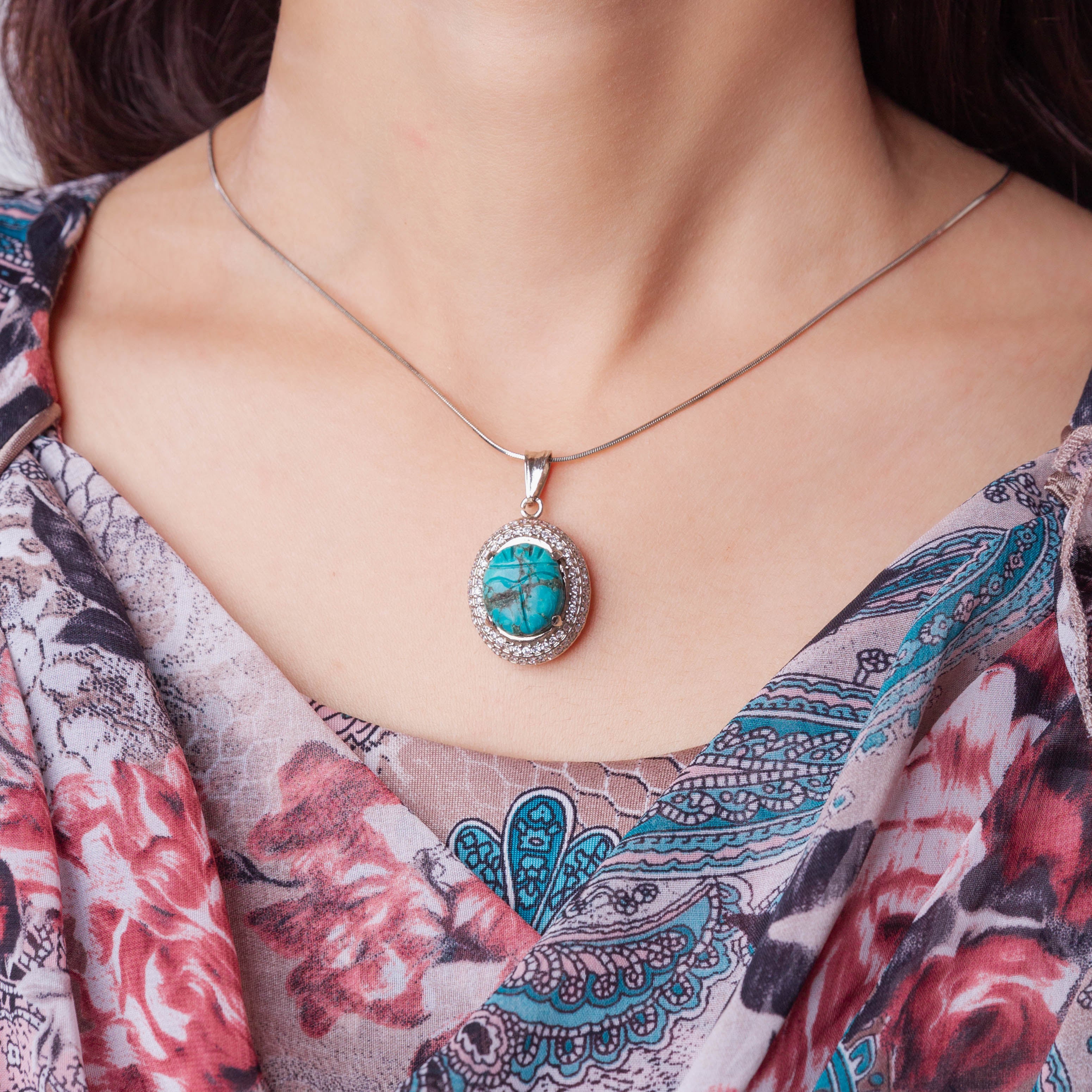 Carved Turquoise Pendant Set in Cubic Zirconia Setting