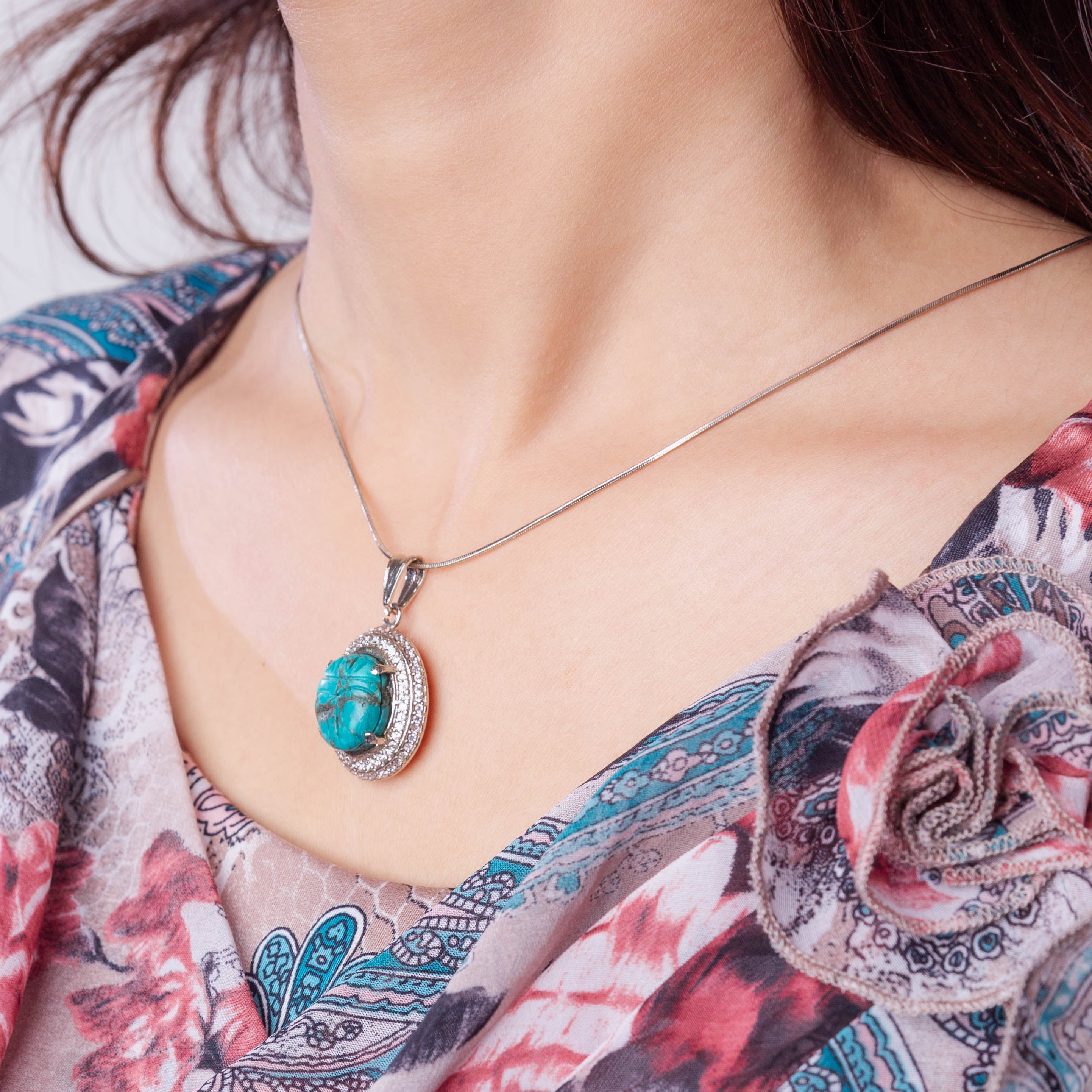 Carved Turquoise Pendant Set in Cubic Zirconia Setting