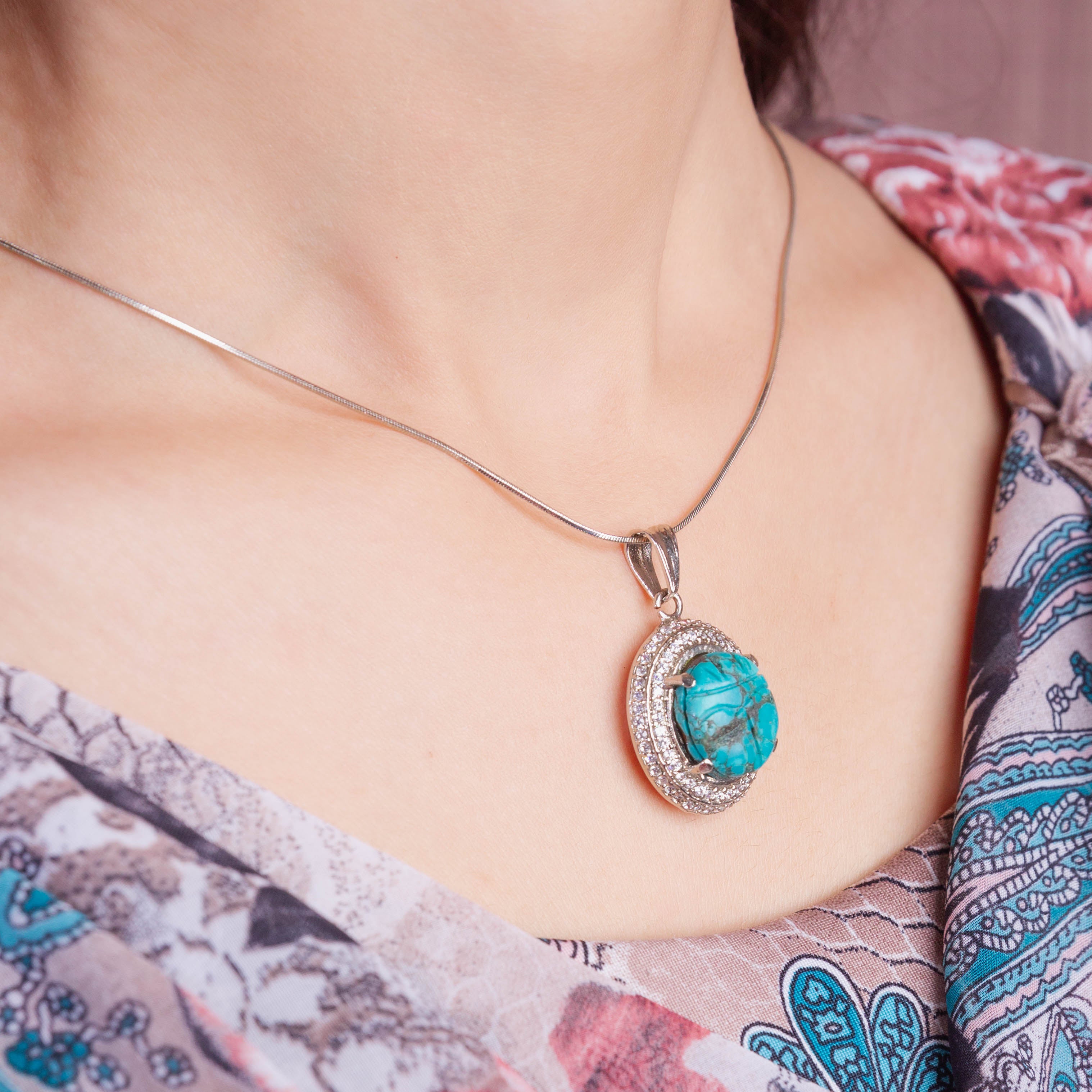 Carved Turquoise Pendant Set in Cubic Zirconia Setting