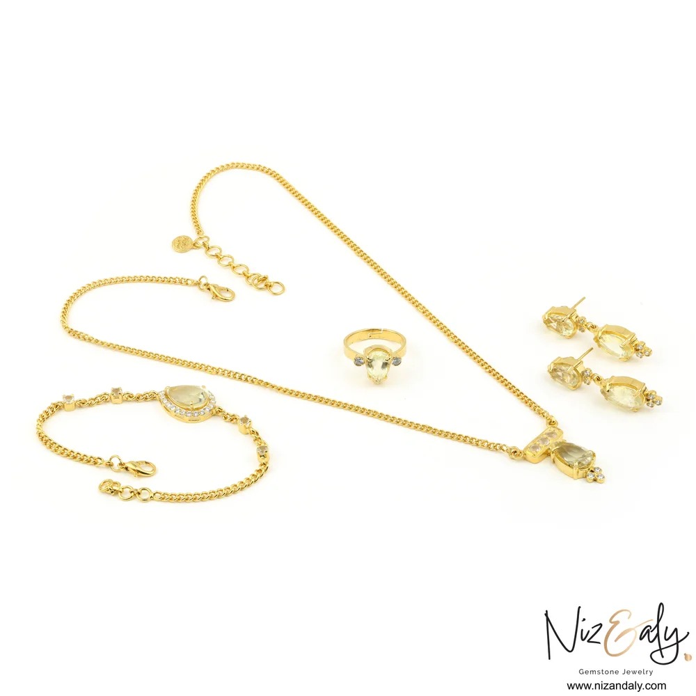 Shop a gold-plated clear quartz pendant set in 925 sterling silver with necklace, bracelet, ring and matching earrings.