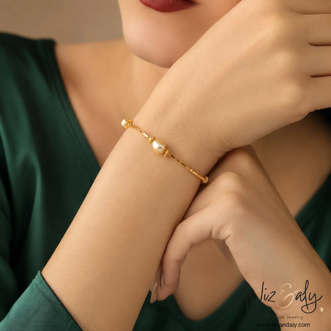Minimalist pearl bracelet with ornate gold caps and connectors