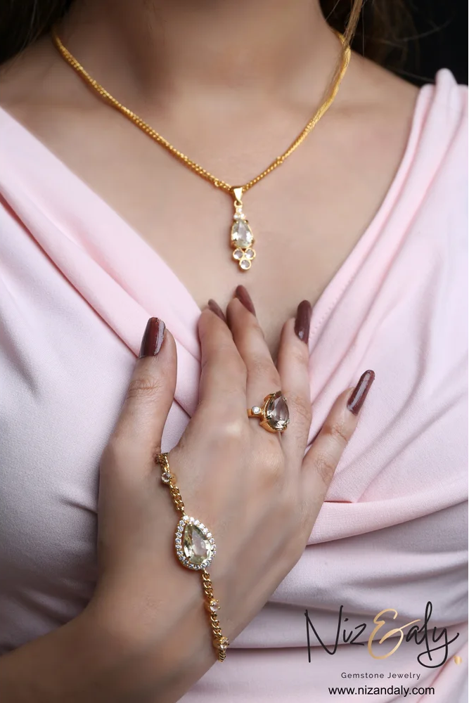 gold plated clear quartz gemstone set close up