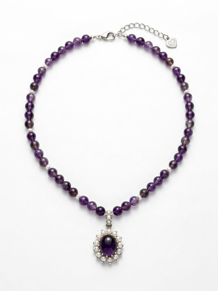 Amethyst pearl pendant on a purple beaded string necklace by Niz & Aly, featuring a teardrop-shaped amethyst and lustrous pearl.