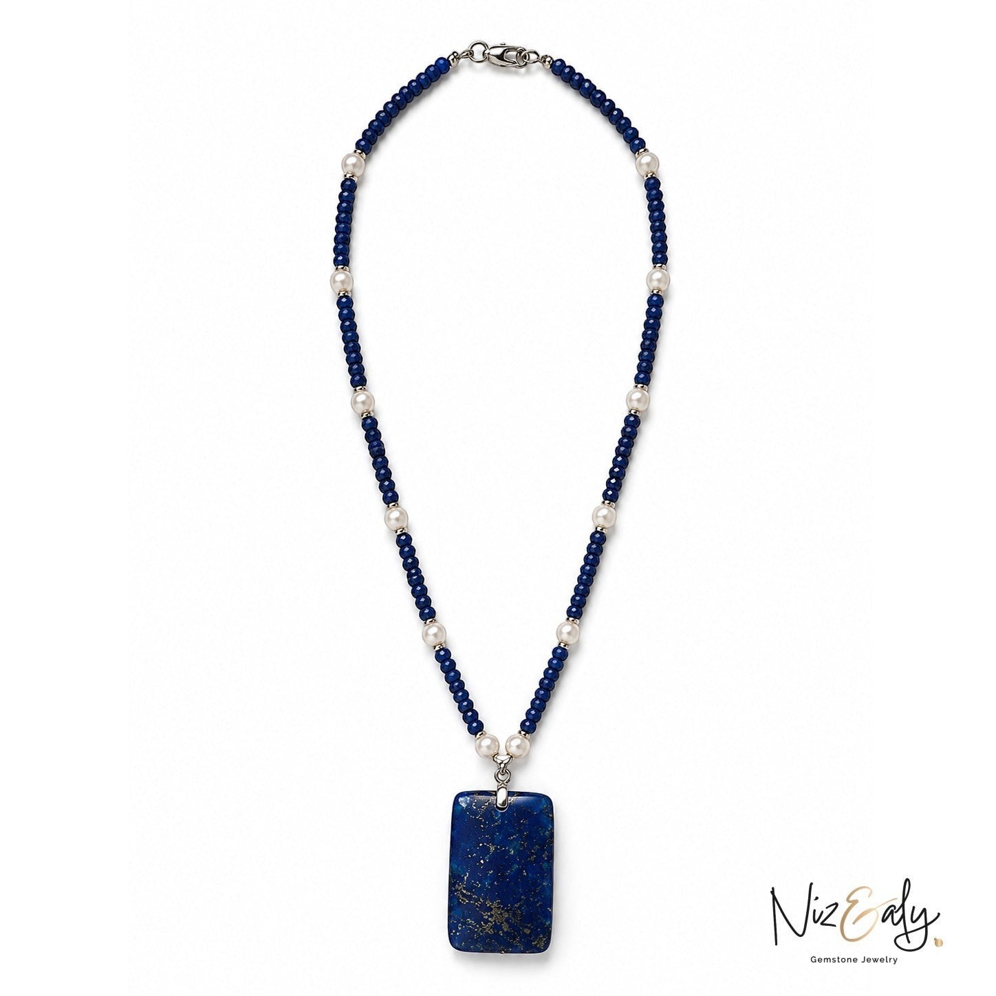 Niz & Aly necklace featuring deep blue gemstone beads, white pearls, and a large rectangular lapis lazuli pendant.