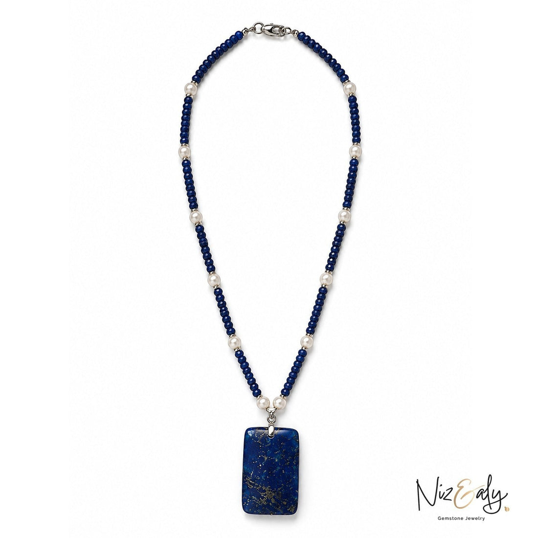 Niz & Aly necklace featuring deep blue gemstone beads, white pearls, and a large rectangular lapis lazuli pendant.