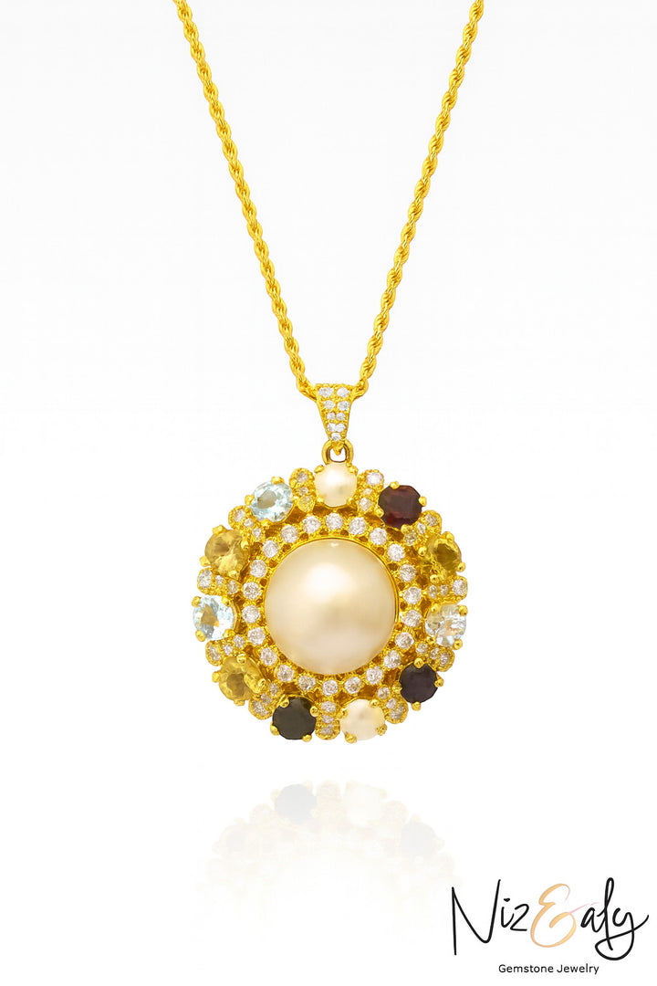 Niz & Aly gold-tone pendant necklace featuring a central pearl, multi-colored gemstones, and a white stone halo.