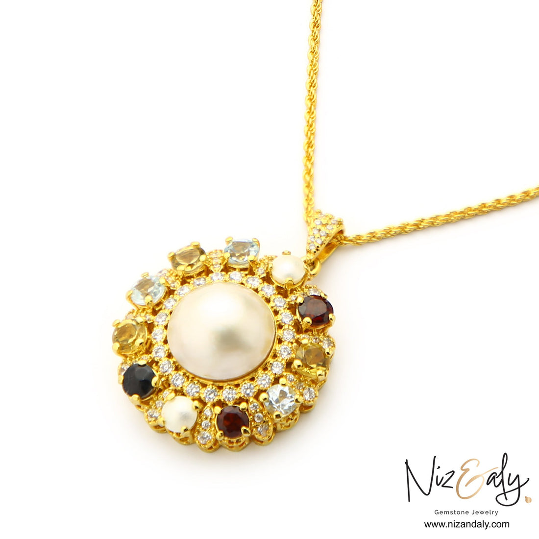 Niz & Aly gold-tone pendant necklace with central pearl, multi-colored gemstones, and white stone halo on rope chain.