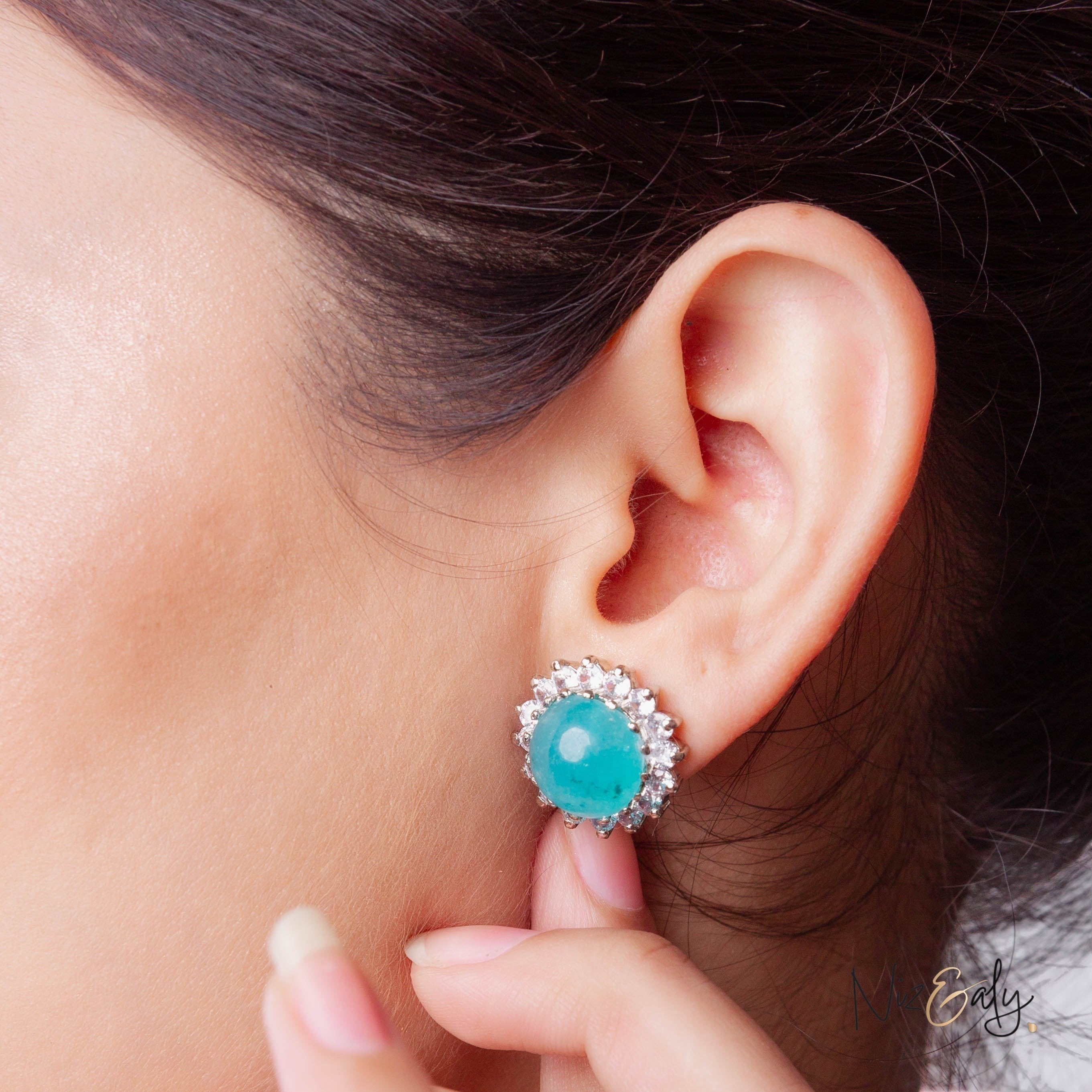 Niz & Aly amazonite stud earring featuring a round blue-green gemstone surrounded by sparkling crystals on an earlobe