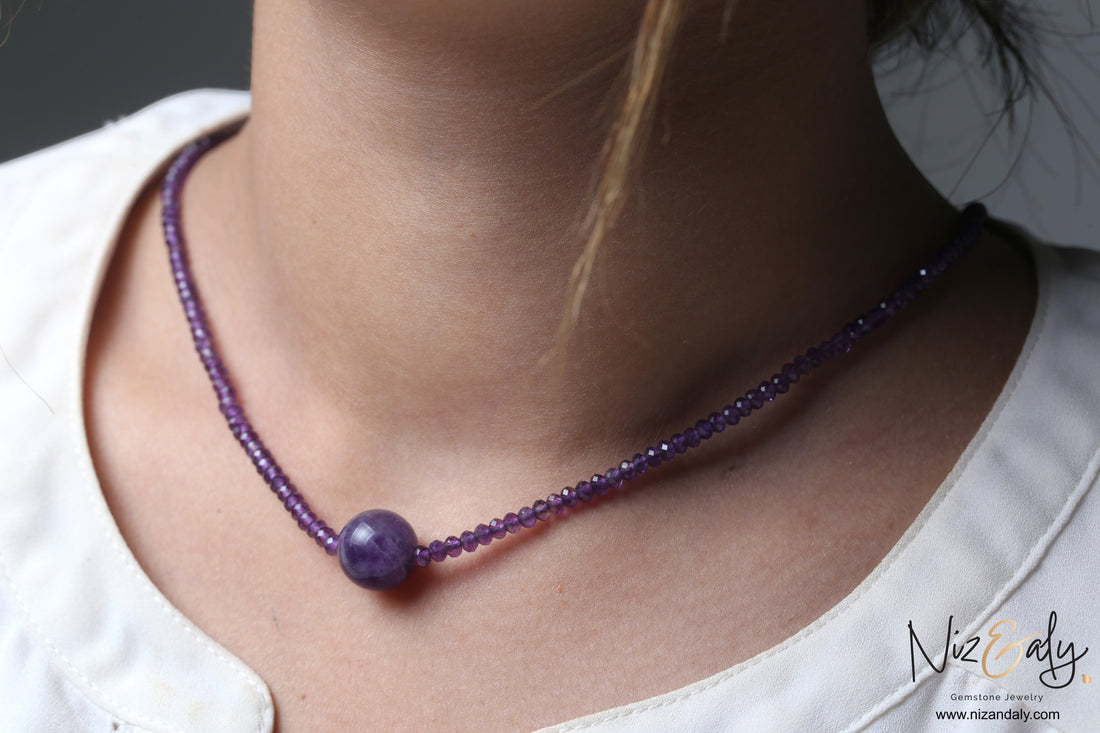 Niz & Aly Celestial Dew necklace featuring a central smooth amethyst sphere on a strand of faceted purple beads