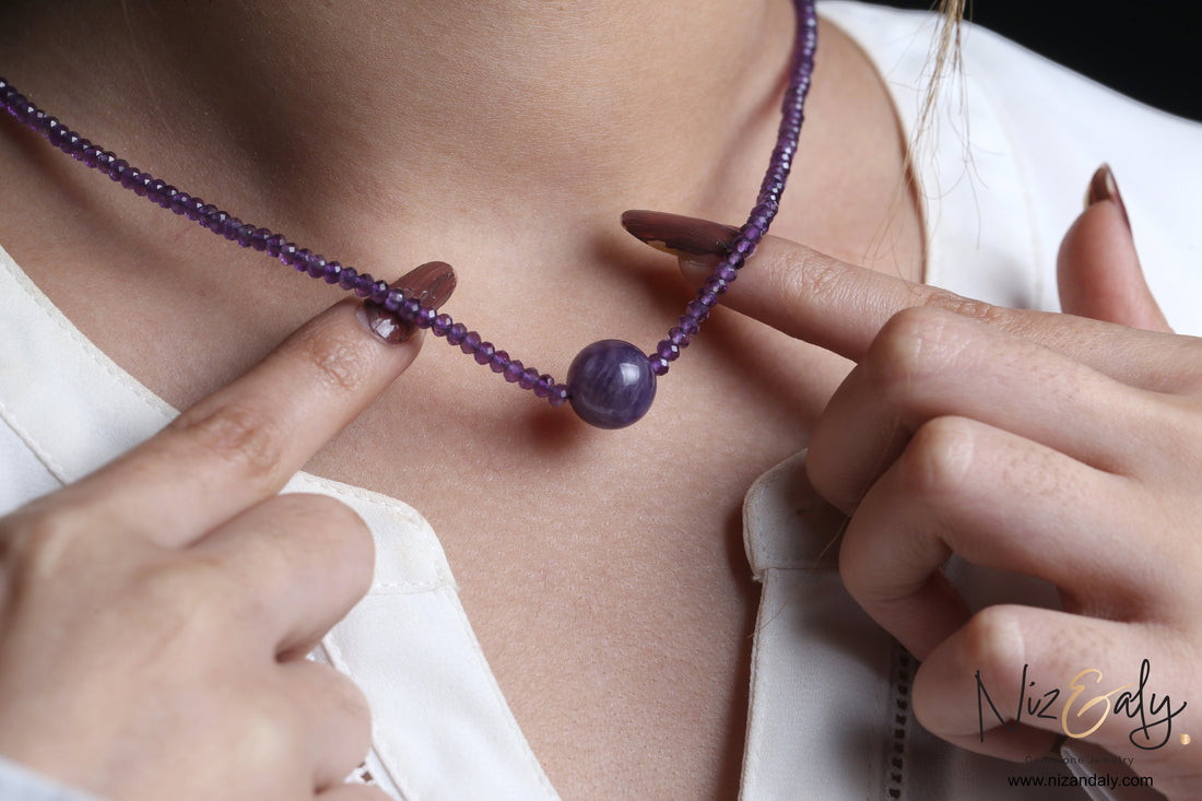 Niz & Aly Celestial Dew necklace featuring a central smooth amethyst sphere on a strand of faceted purple beads