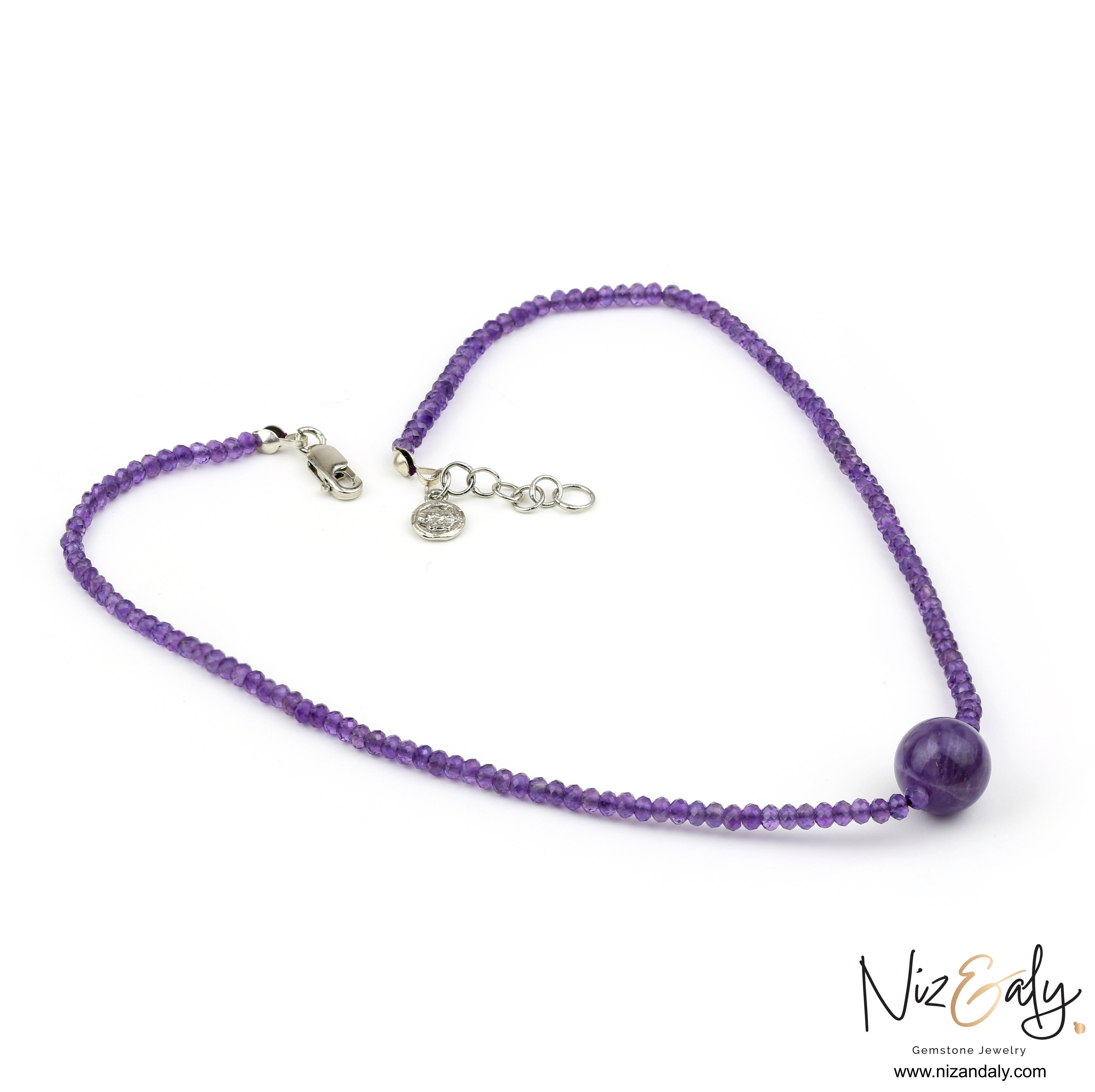 Niz & Aly Celestial Dew amethyst necklace featuring faceted purple beads and a central smooth amethyst sphere.