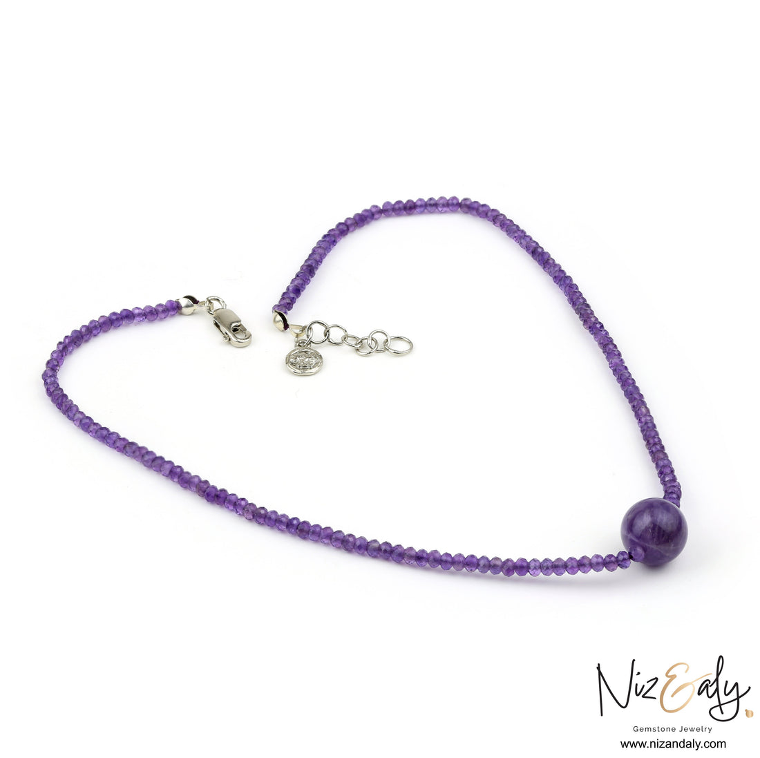 Niz & Aly Celestial Dew amethyst necklace featuring faceted purple beads and a central smooth amethyst sphere.