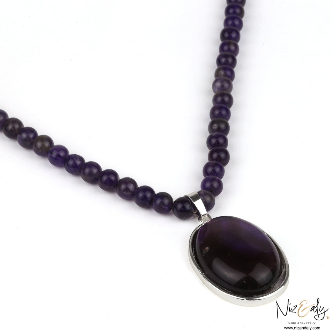 Niz & Aly amethyst gemstone necklace featuring a polished oval pendant on a strand of natural purple amethyst beads.