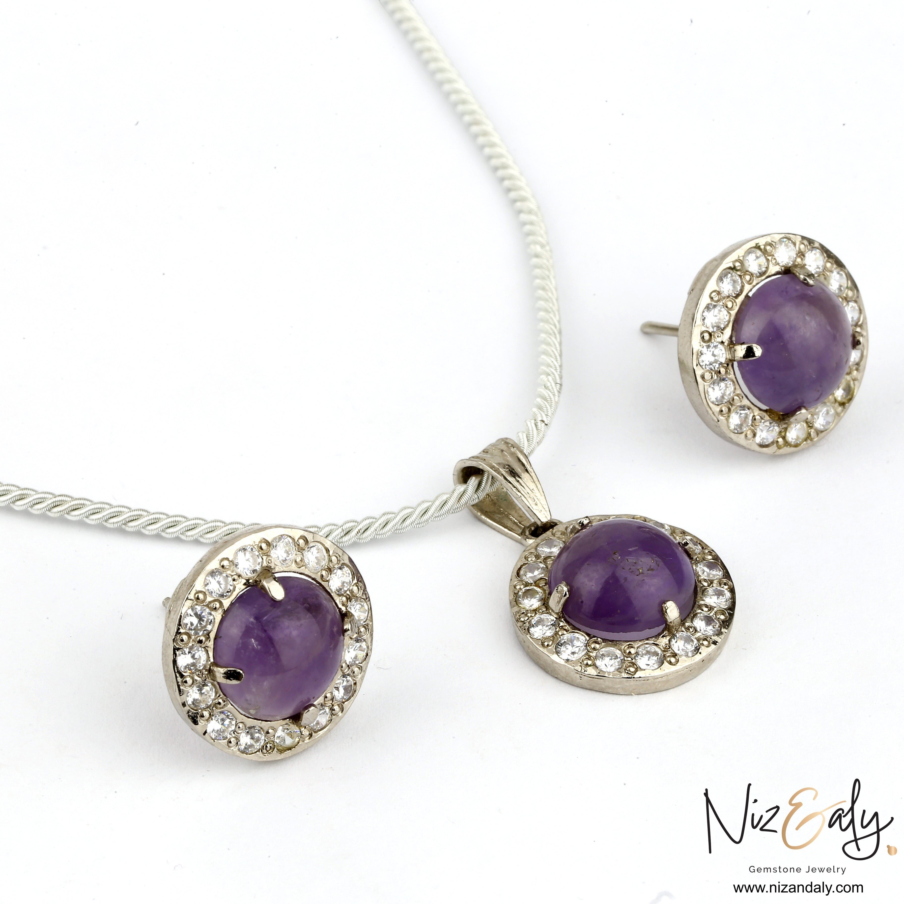 Niz & Aly amethyst constellation pendant and earring set with violet cabochon stones and sparkling crystal accents.