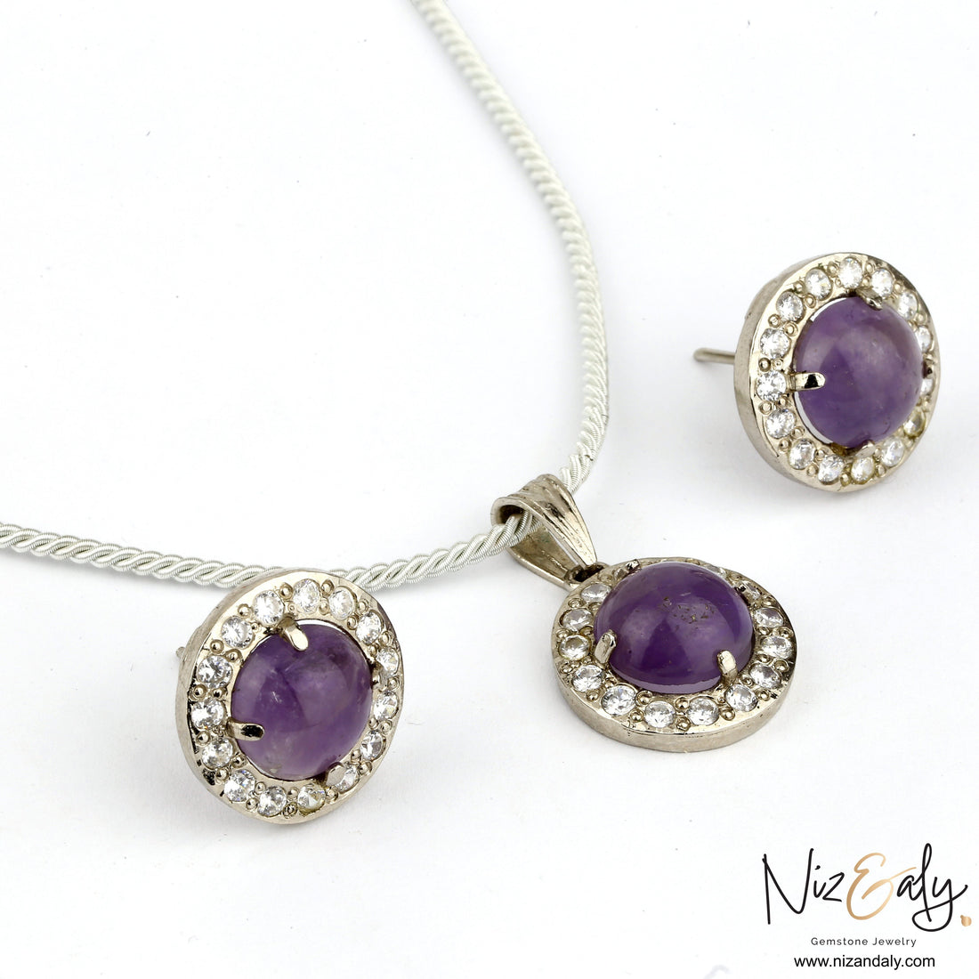 Niz & Aly amethyst constellation pendant and earring set with violet cabochon stones and sparkling crystal accents.
