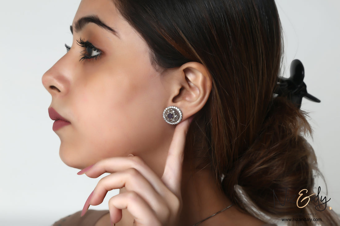 Niz & Aly round natural amethyst and white cubic zirconia stud earring worn by a woman in profile view