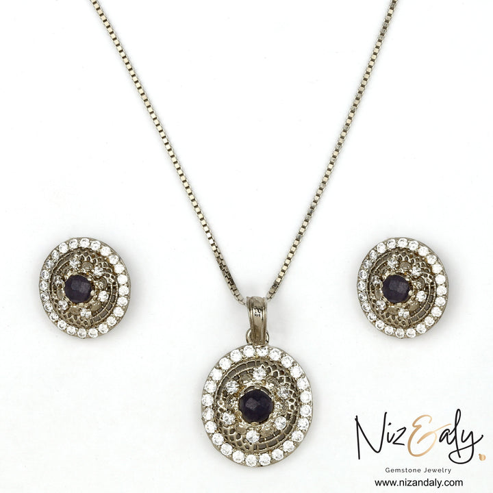 Niz & Aly round natural amethyst pendant and earring set with white cubic zirconia accents in a silver-tone finish.