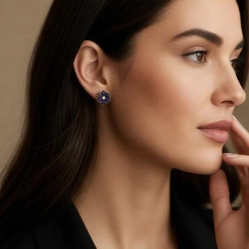 Niz & Aly amethyst flower ear studs worn by a woman, featuring deep purple gemstone petals in a delicate floral design.