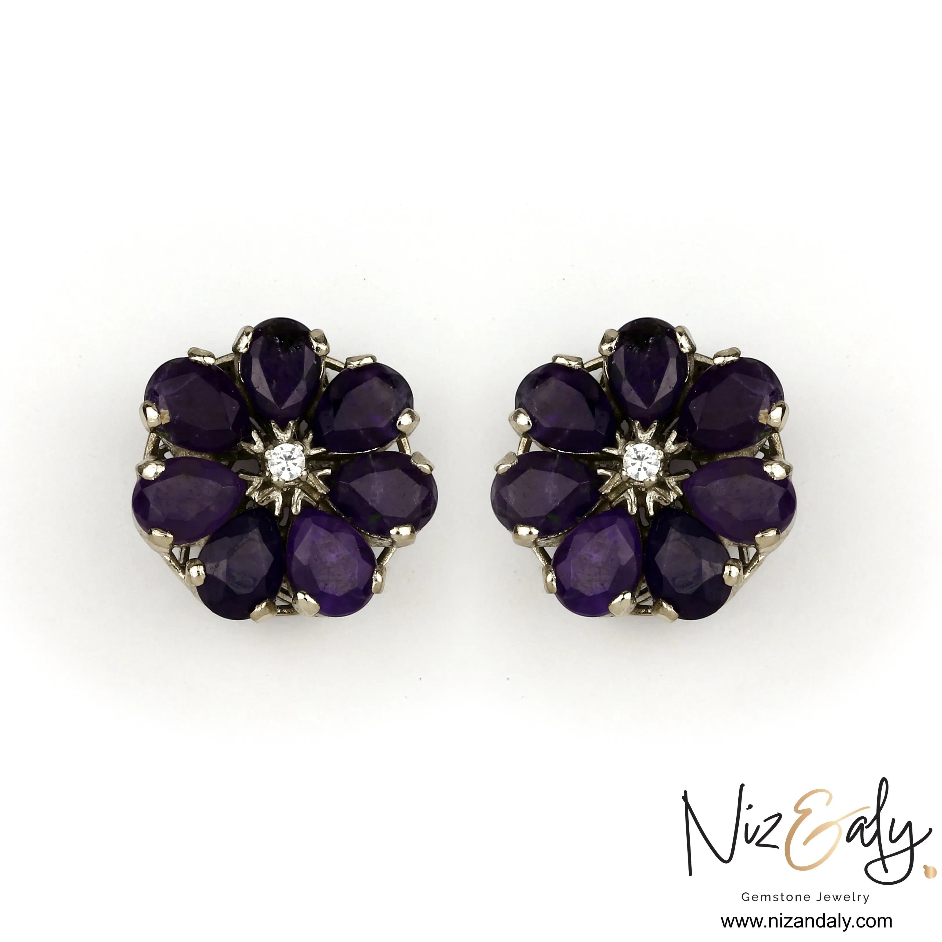 Niz & Aly amethyst flower ear studs featuring deep purple teardrop petals and a central clear stone in a floral setting.