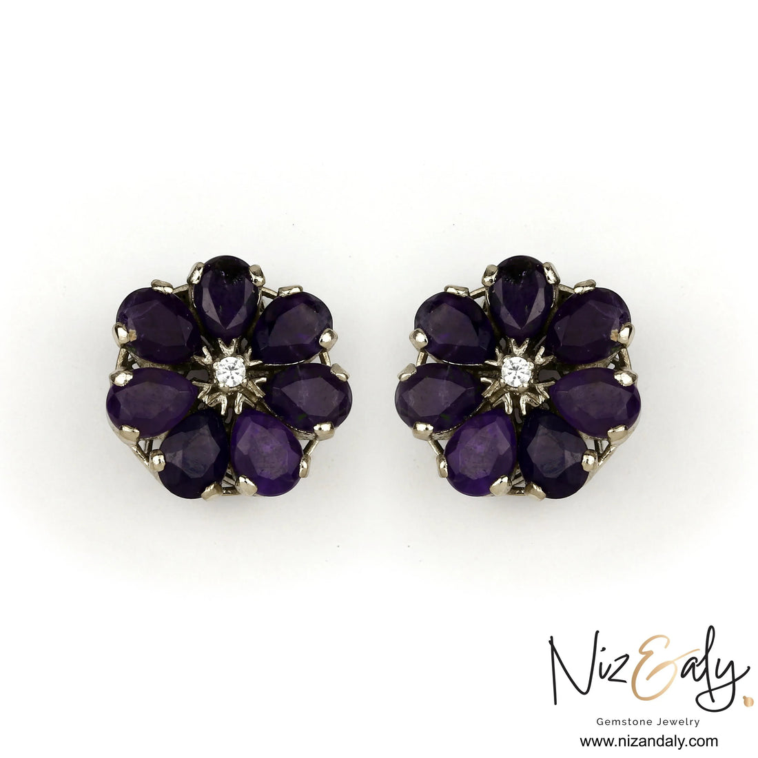 Niz & Aly amethyst flower ear studs featuring deep purple teardrop petals and a central clear stone in a floral setting.