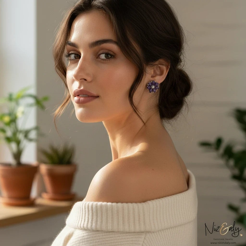 Niz & Aly amethyst flower ear studs worn by a woman in a white off-shoulder top, featuring purple floral gemstones.