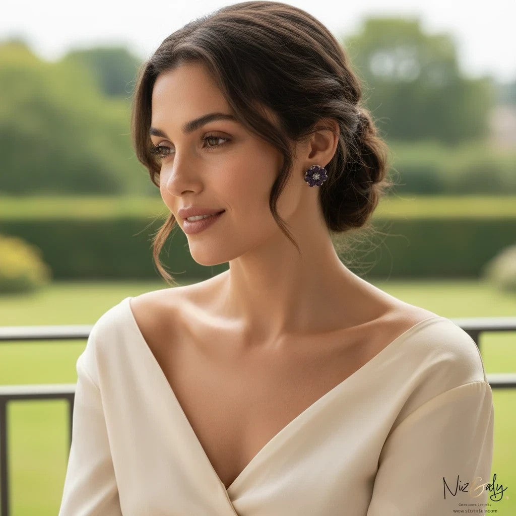 Niz & Aly amethyst flower ear studs worn by a woman in a cream dress, featuring purple gemstone petals.