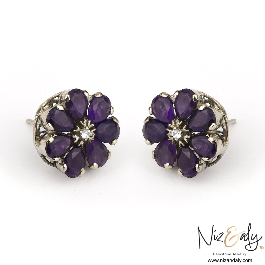 Niz & Aly amethyst flower ear studs with purple teardrop gemstones and a central diamond in a silver setting.