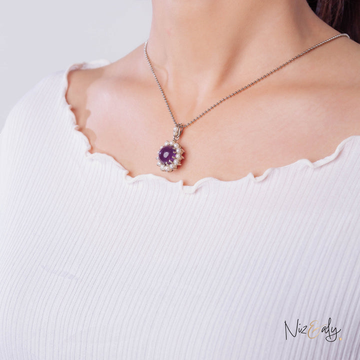 Niz & Aly necklace featuring a round purple amethyst cabochon surrounded by small white freshwater pearls on a chain