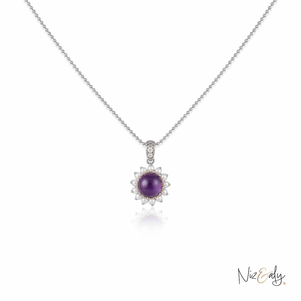 Niz & Aly necklace featuring a round purple amethyst stone surrounded by a halo of small white freshwater pearls.