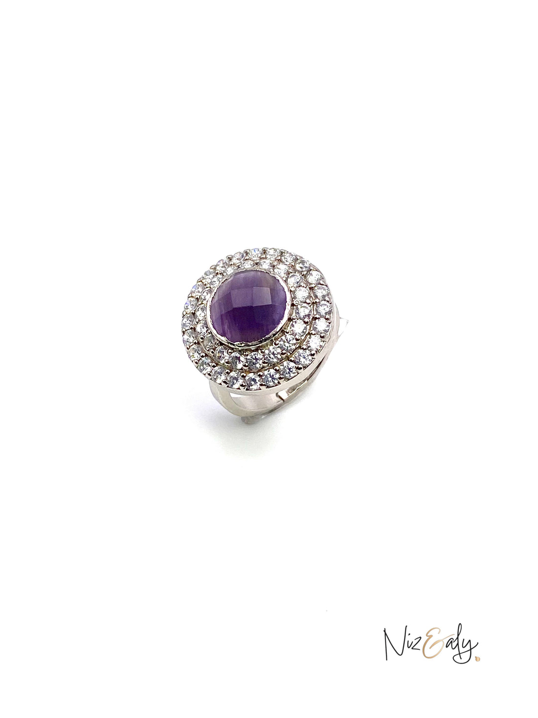 Niz & Aly amethyst hemisphere ring with a halo of sparkling white stones set in a polished silver band.