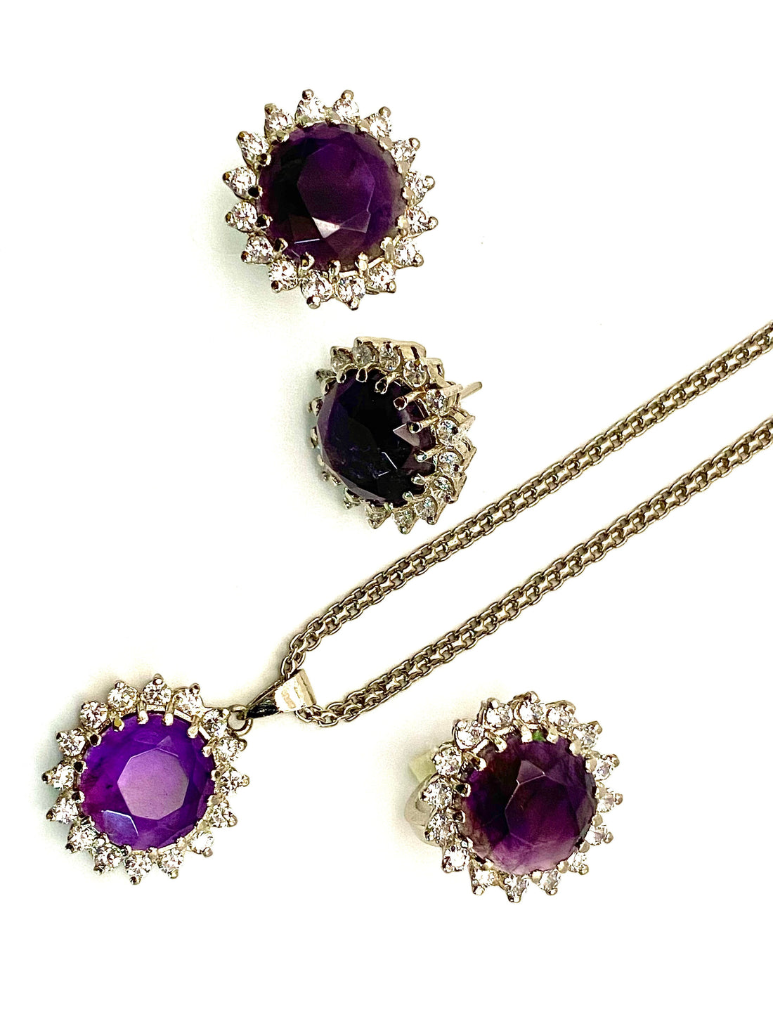 Niz & Aly Amethyst Serenity Locket Set featuring deep purple amethyst stones surrounded by sparkling clear crystals.