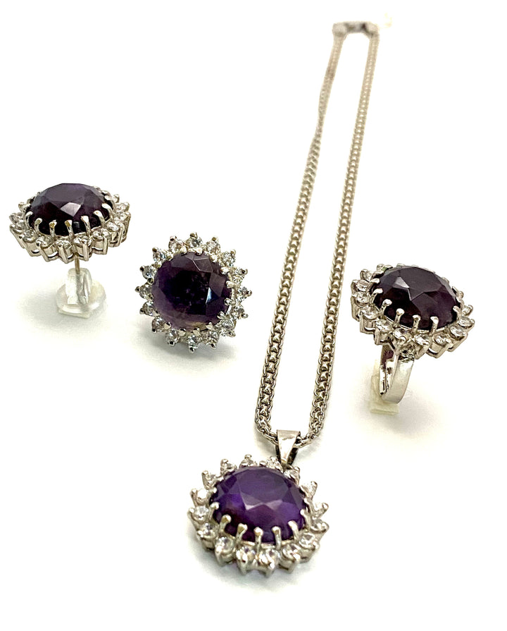 Niz & Aly Amethyst Serenity Locket Set featuring a silver necklace, ring, and stud earrings with purple gemstones.