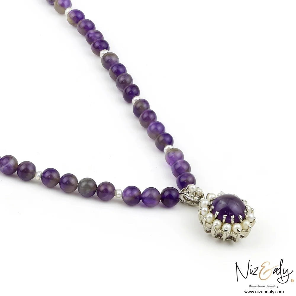 Niz & Aly amethyst and pearl pendant necklace featuring a beaded amethyst strand and silver setting