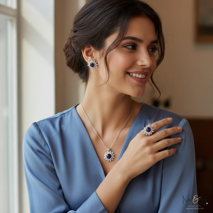 Niz & Aly amethyst pendant set with matching earrings and ring worn by a smiling woman in a blue blouse