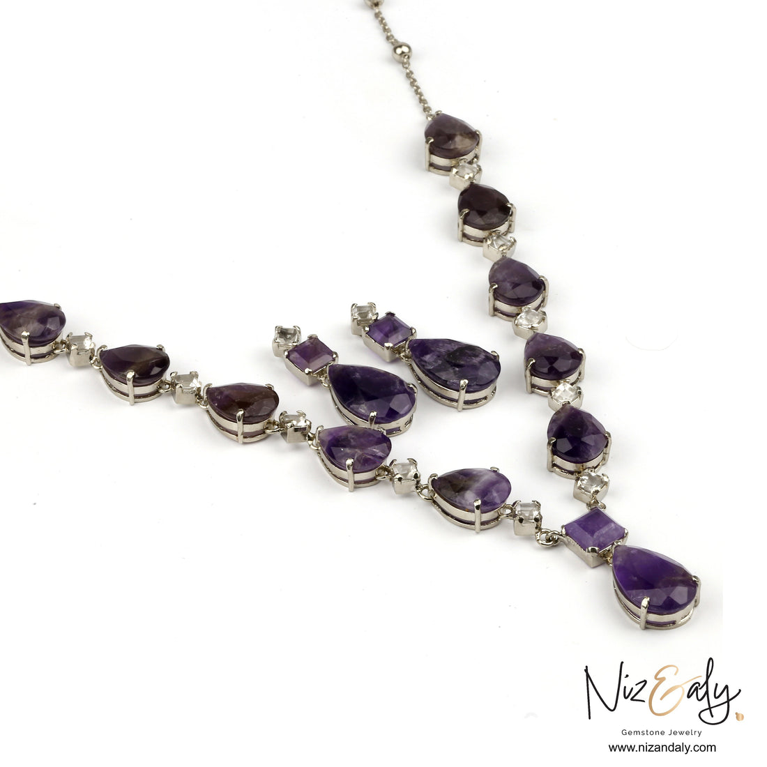 Niz & Aly necklace and earring set featuring dark droplet-shaped amethyst and clear quartz stones in silver settings.