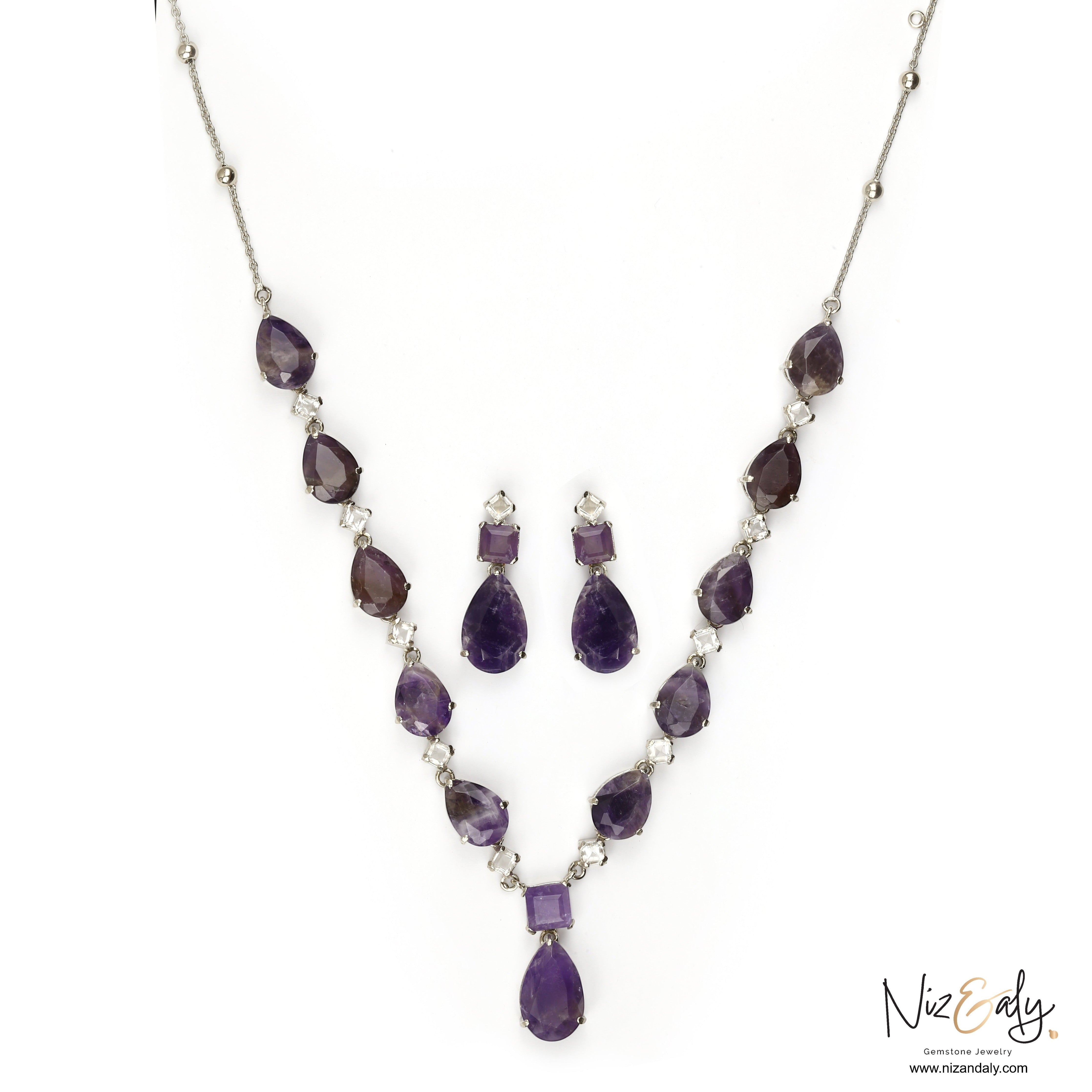 Niz & Aly necklace and earring set featuring droplet-cut amethyst gemstones and clear quartz accents in silver.