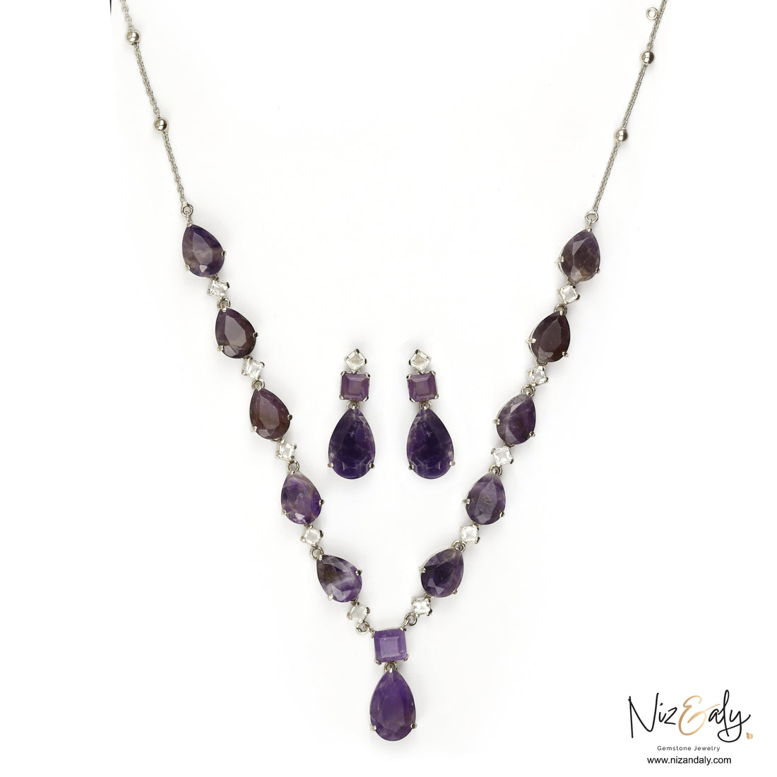 Niz & Aly necklace and earring set featuring droplet-cut amethyst gemstones and clear quartz accents in silver.