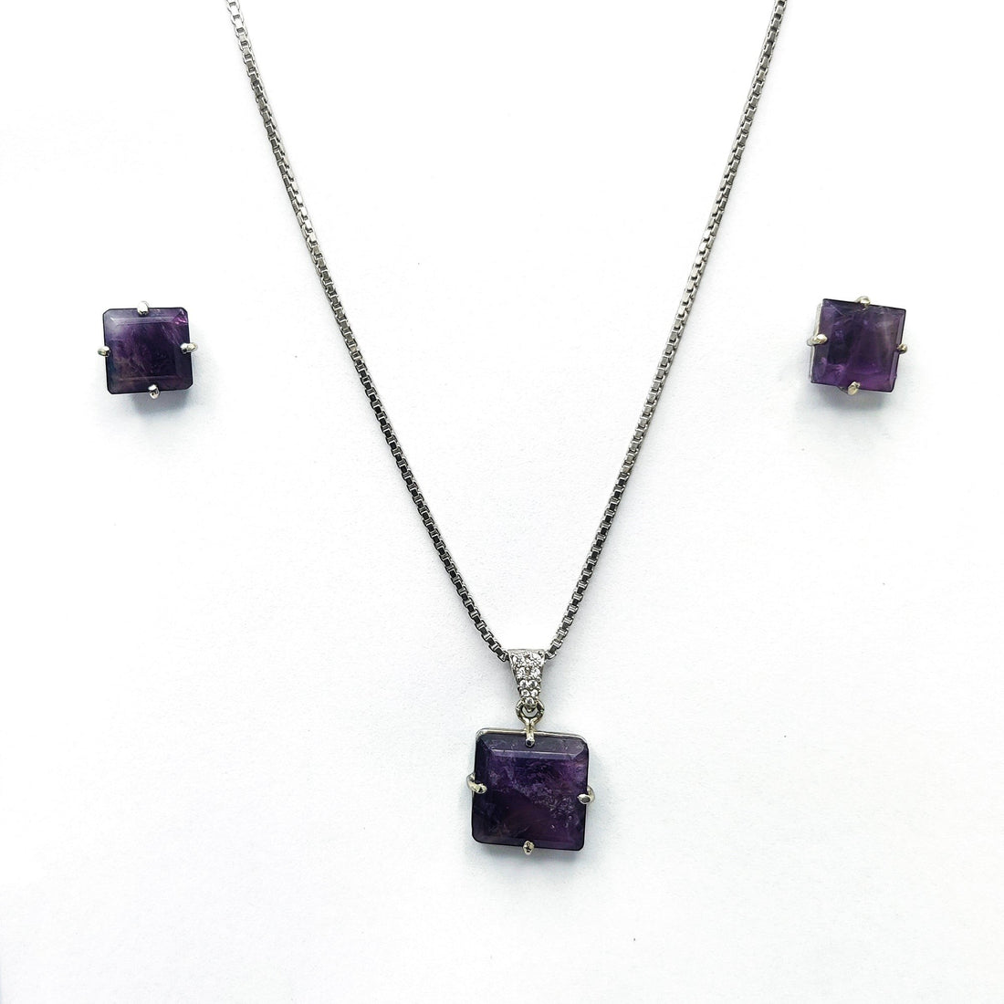 Niz & Aly square amethyst locket necklace and matching stud earrings set in silver on a white background