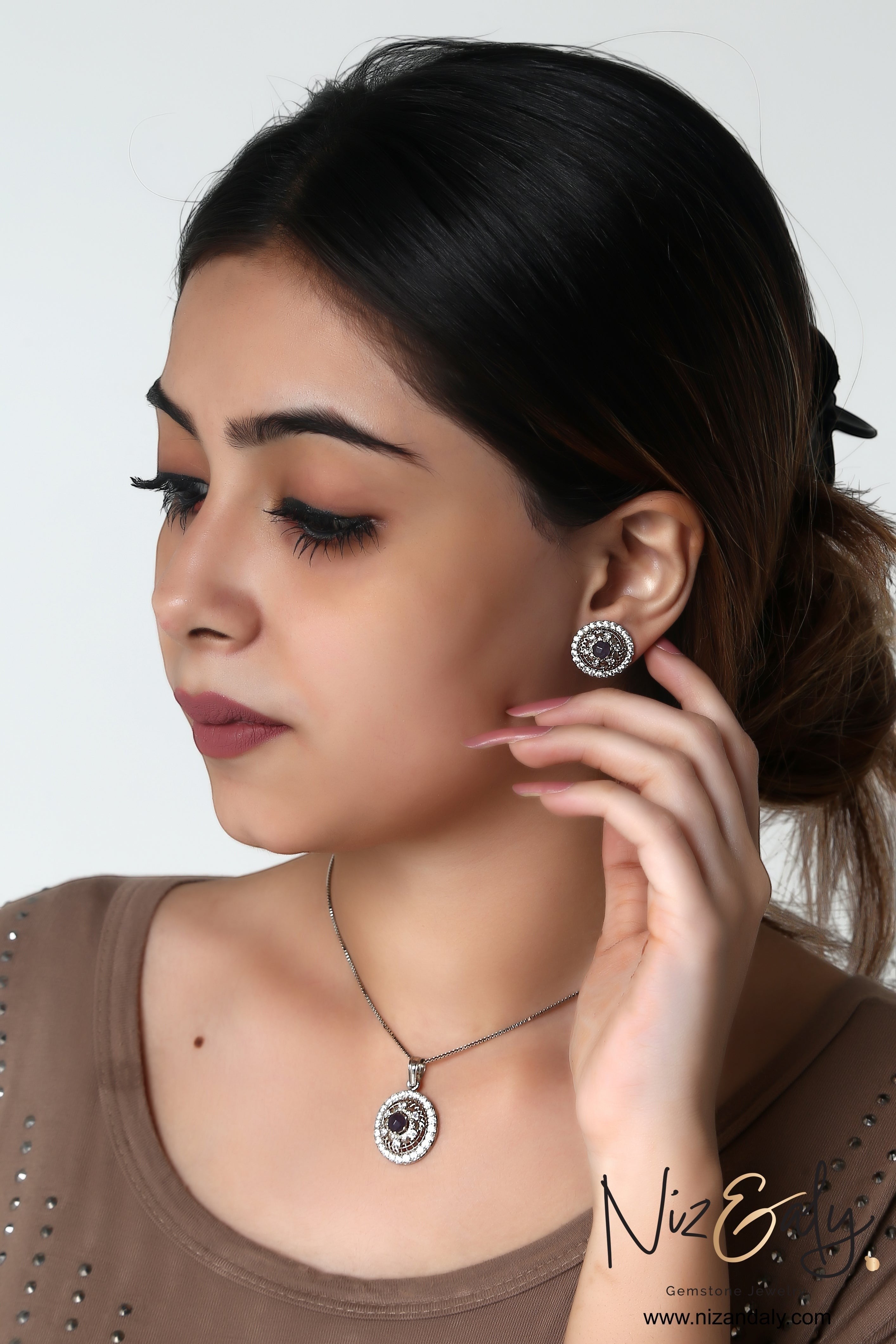 Niz & Aly round natural amethyst pendant and earring set with sparkling white cubic zirconia on a model