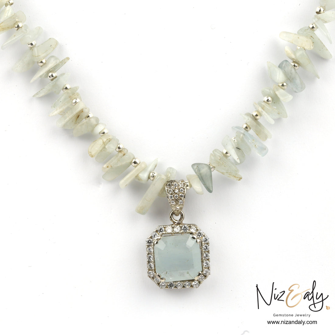 Niz & Aly aquamarine pendant necklace featuring a square gemstone pendant on a strand of raw aqua-hued chip beads.