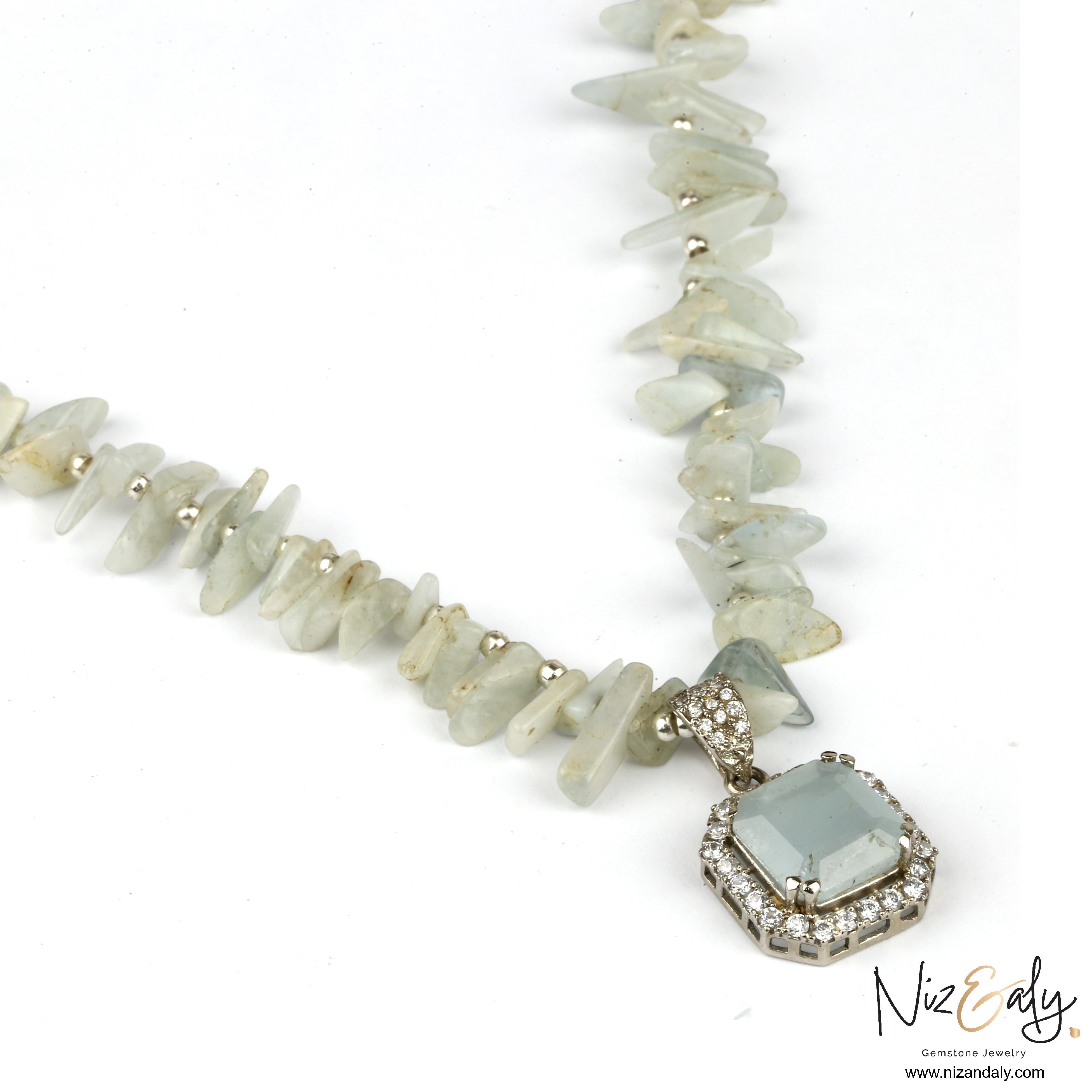 Niz & Aly natural aquamarine pendant necklace with pale blue gemstone chips and a sparkling crystal halo setting.