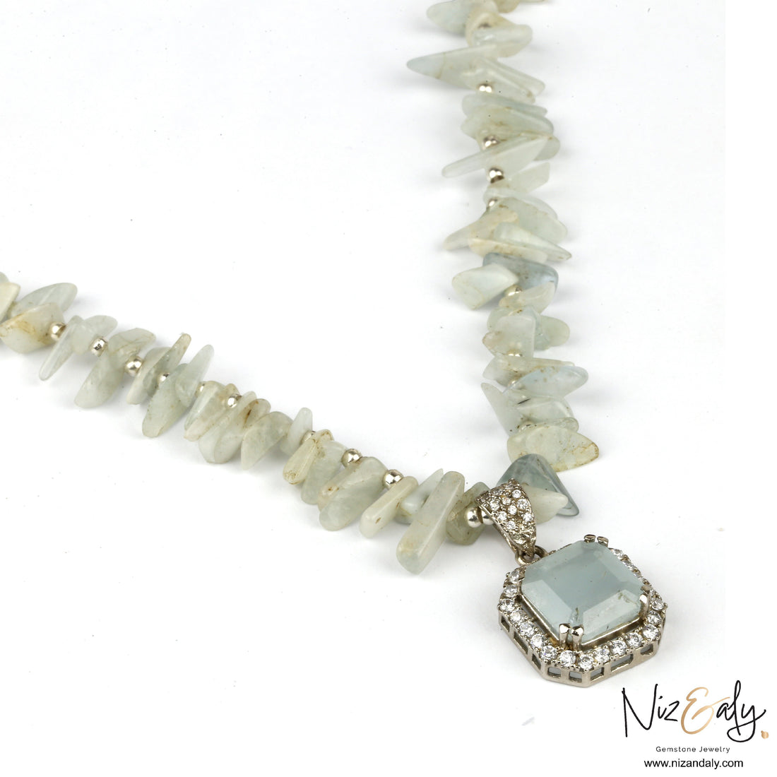 Niz & Aly natural aquamarine pendant necklace with pale blue gemstone chips and a sparkling crystal halo setting.