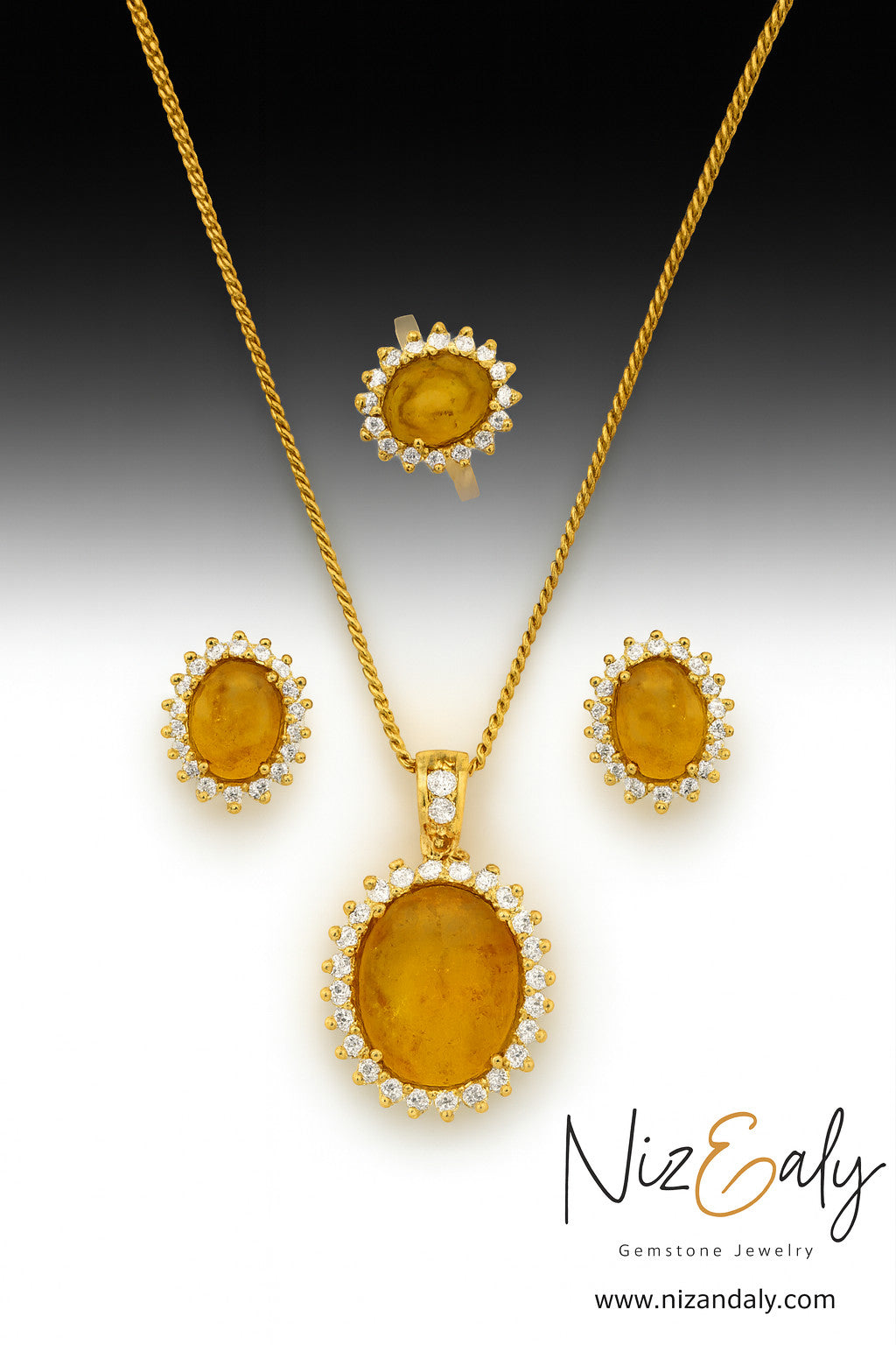 Niz & Aly natural Baltic amber jewelry set featuring a gold-plated pendant, earrings, and ring with clear stone halos.