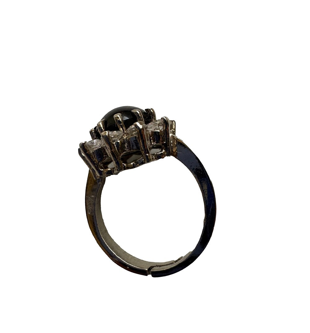 Niz & Aly adjustable ring featuring a polished black onyx gemstone surrounded by clear crystals in a silver setting.
