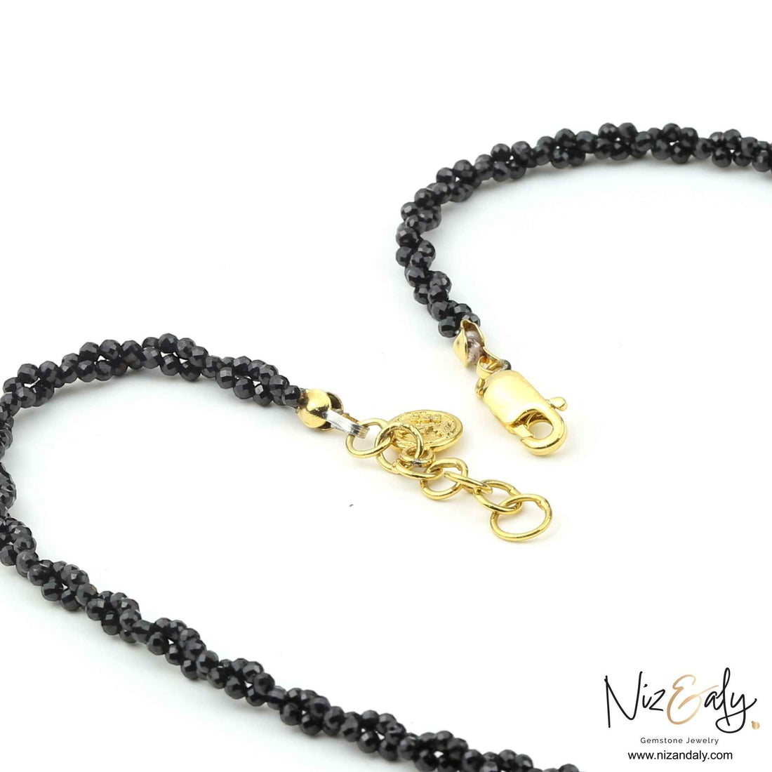 Niz & Aly necklace featuring a strand of faceted black onyx beads with a gold-tone lobster clasp and extender chain.