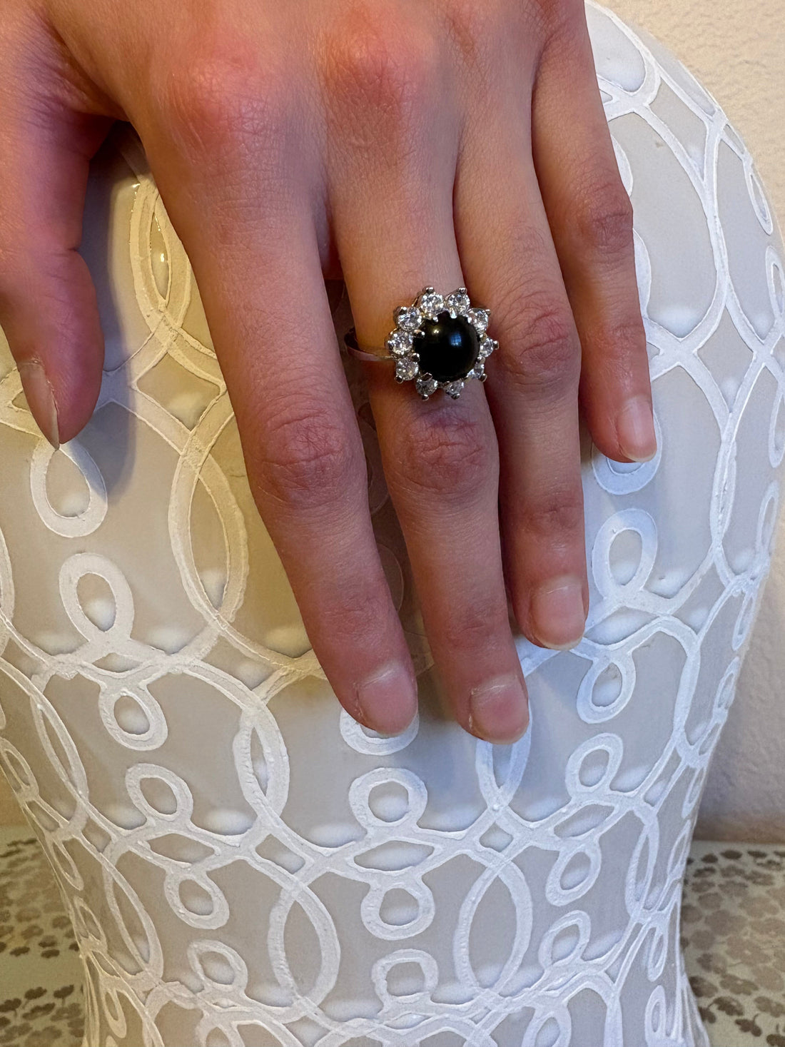 Niz & Aly natural black onyx ring featuring a halo of sparkling white stones on a silver adjustable band