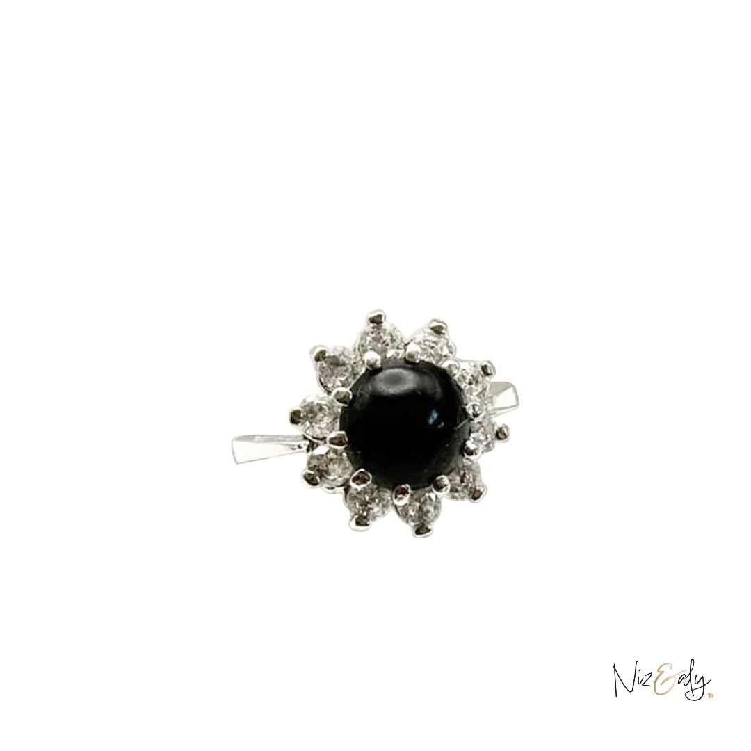 Niz & Aly round black onyx statement ring surrounded by a halo of sparkling white crystals on a silver band.