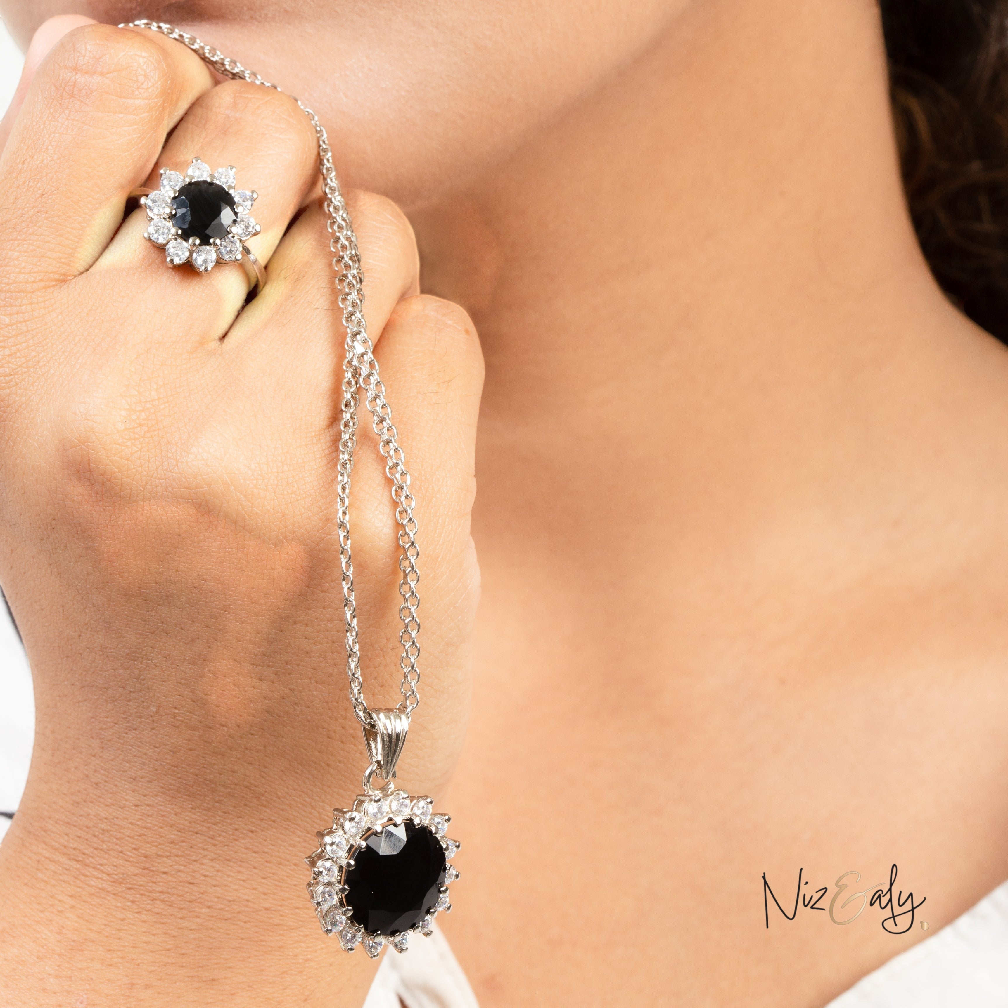 Niz & Aly Timeless Black Onyx Set featuring a polished black onyx pendant necklace and matching floral-style ring