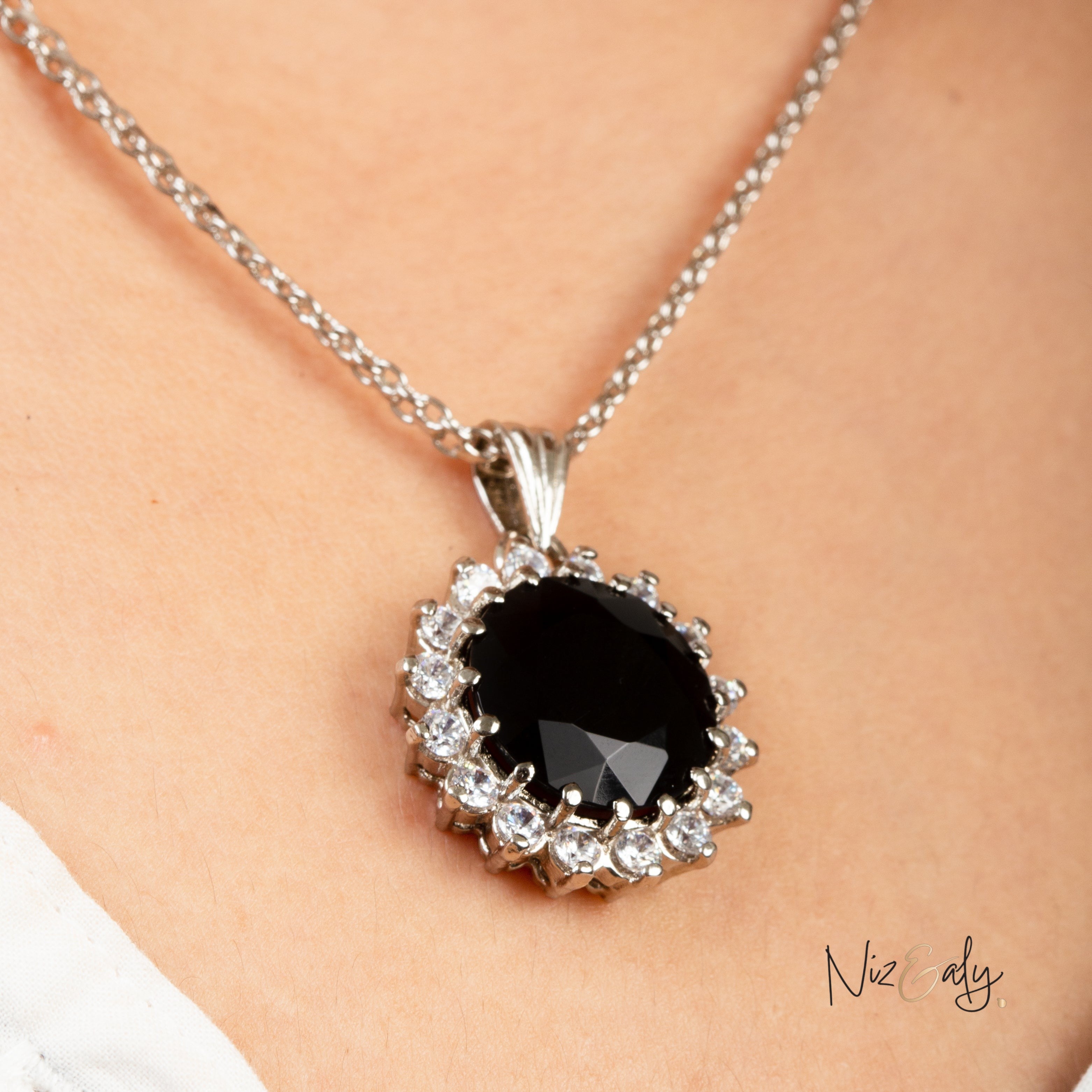 Niz & Aly Timeless Black Onyx pendant necklace featuring a polished black gemstone surrounded by sparkling white crystals.