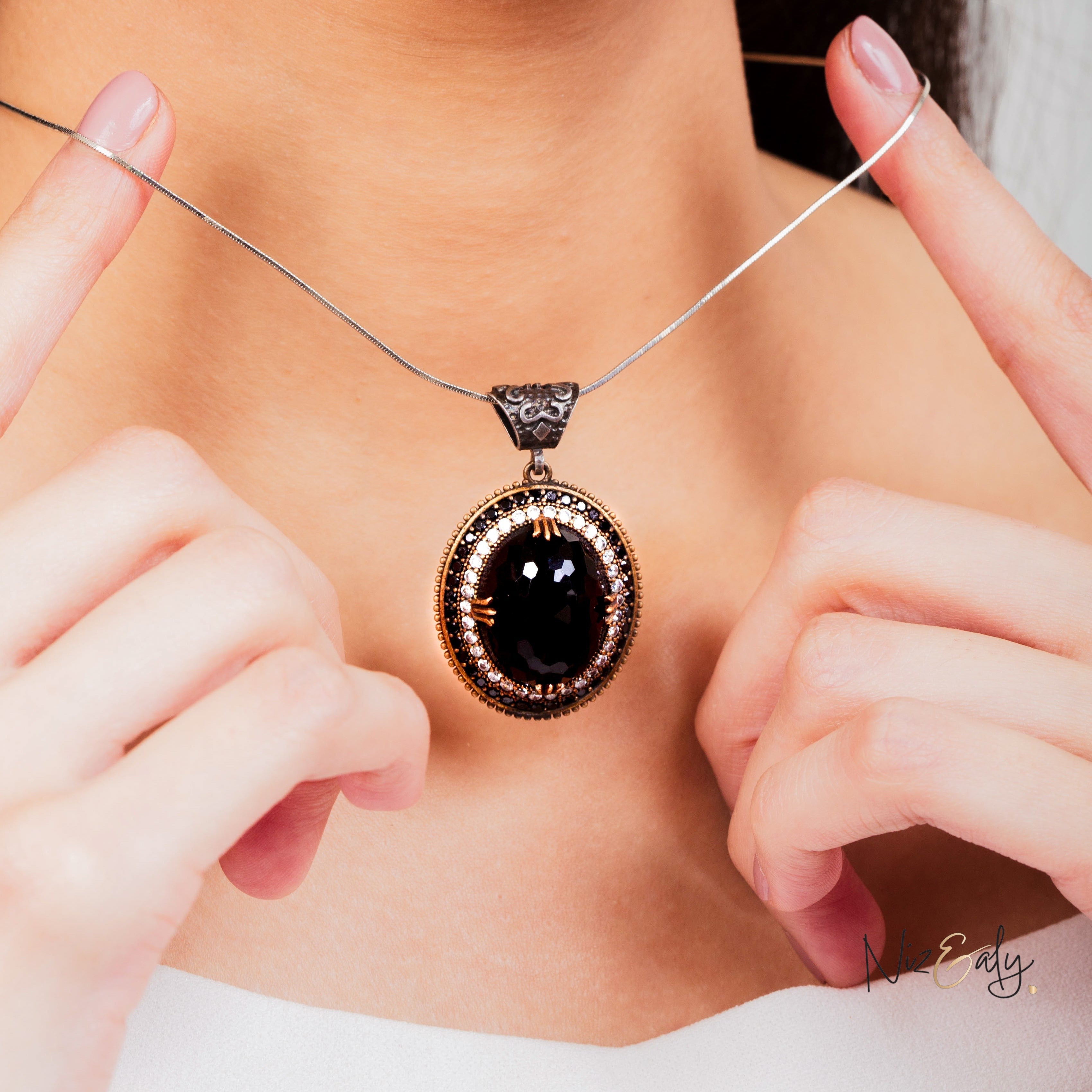 Niz & Aly faceted black onyx pendant necklace with VVS cubic zirconia and tiny onyx accents worn on a silver chain